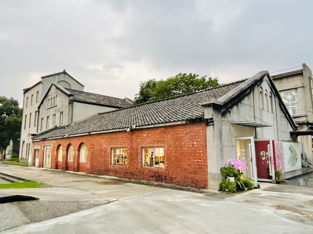 a-brick-building-with-a-driveway-mi3znksnmcm